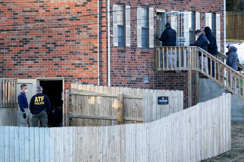 FBI and ATF agents investigate a home Saturday, Dec. 26, 2020, in Nashville, Tenn. An explosion that shook the largely deserted streets of downtown Nashville early Christmas morning shattered windows, damaged buildings, and wounded three people. Authorities said they believed the blast was intentional. (AP Photo/Mark Humphrey)
