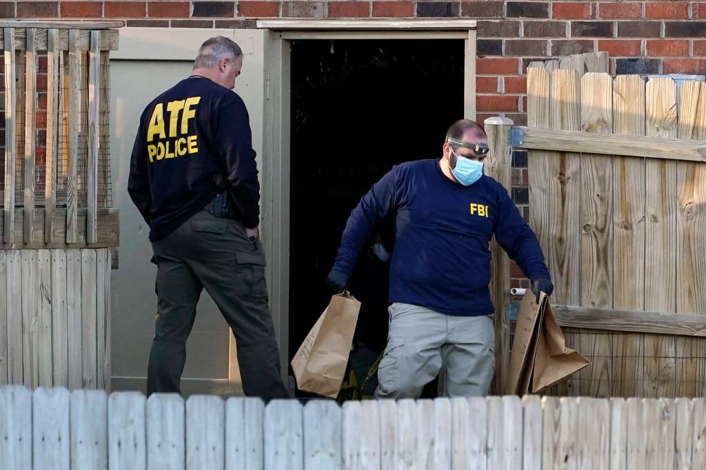 Investigators remove items from the basement of a home Saturday, Dec. 26, 2020, in Nashville, Tenn. An explosion that shook the largely deserted streets of downtown Nashville early Christmas morning shattered windows, damaged buildings, and wounded three people. Authorities said they believed the blast was intentional. (AP Photo/Mark Humphrey)