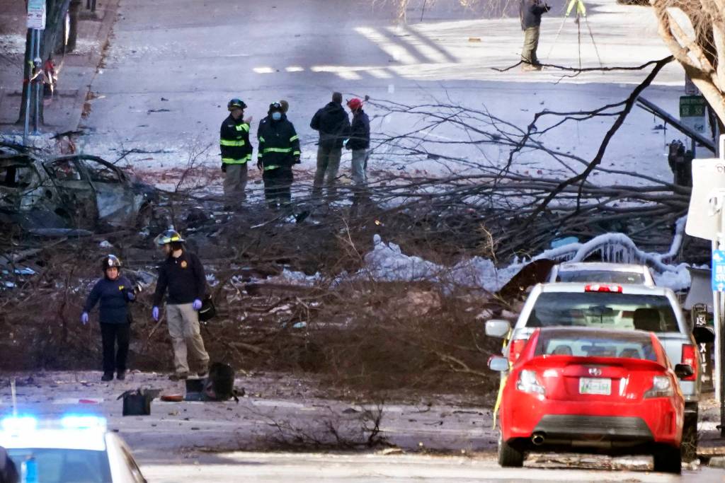 Investigators work at the scene of an explosion Saturday, Dec. 26, 2020, in Nashville, Tenn. The explosion that shook the largely deserted streets of downtown Nashville early Christmas morning shattered windows, damaged buildings and wounded three people. Authorities said they believed the blast was intentional. (AP Photo/Mark Humphrey)