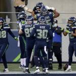 Seattle Seahawks tight end Jacob Hollister (86), top, celebrates with teammates after he caught a pass for a touchdown against the Los Angeles Rams during the second half of an NFL football game, Sunday, Dec. 27, 2020, in Seattle. (AP Photo/Scott Eklund)