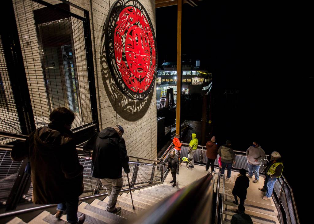 People make their way up and down the east stairway at the new Mukilteo ferry terminal on Tuesday. (Olivia Vanni / The Herald)