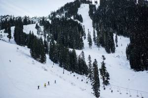 People make their way up and down the mountain on opening day at Steven's Pass on Friday, Dec. 4, 2020 in Skykomish, Wa. (Olivia Vanni / The Herald)