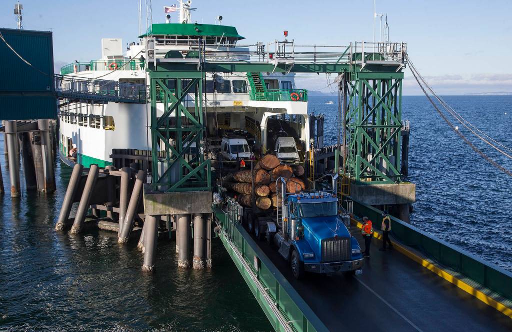 A semitruck hauling large logs spilled its cargo on the ramp of the Edmonds ferry terminal Monday, stranding the MV Spokane at the dock. (Andy Bronson / The Herald)