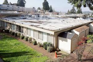 The single-story Life Care Center is seen Wednesday, March 18, 2020, in Kirkland, Wash. Staff members who worked while sick at multiple long-term care facilities contributed to the spread of COVID-19 among vulnerable elderly in the Seattle area, federal health officials said Wednesday. (AP Photo/Elaine Thompson)