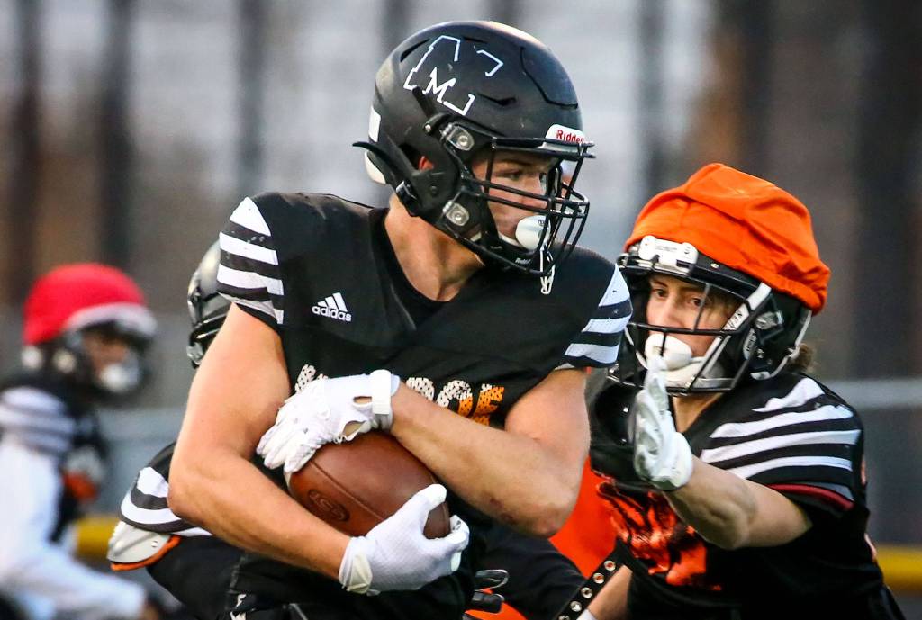 Monroes Blake Rybar rushes during a football practice in 2019 at Monroe High School. (Kevin Clark / The Herald)