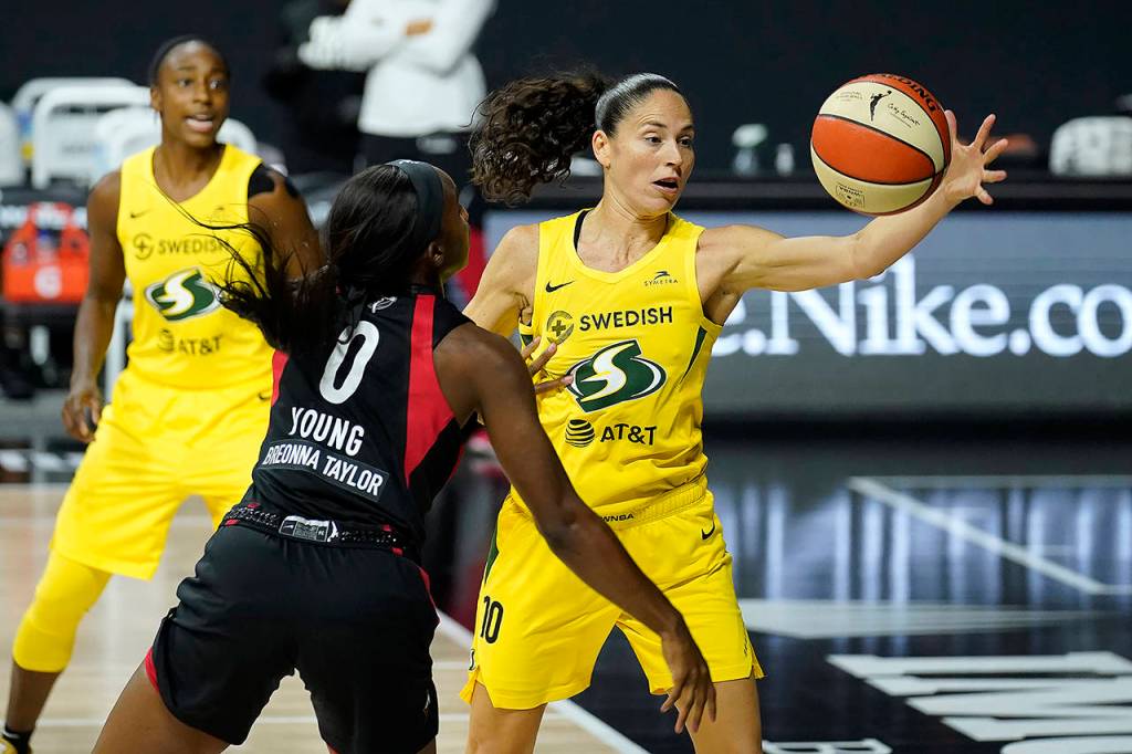 Seattle Storm guard Sue Bird (10) grabs the ball away from Las Vegas Aces guard Jackie Young (0) during Game 3 of basketballs WNBA Finals on Oct. 6 in Bradenton, Florida. The Storm winning the league championship, with the biggest margin of victory in WNBA Finals and the fourth title for the franchise, was among Washington states top stories for 2020. (AP Photo/Chris OMeara, File)