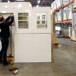 Weatherstripping is installed at Pallet in Everett. (Kevin Clark / The Herald)