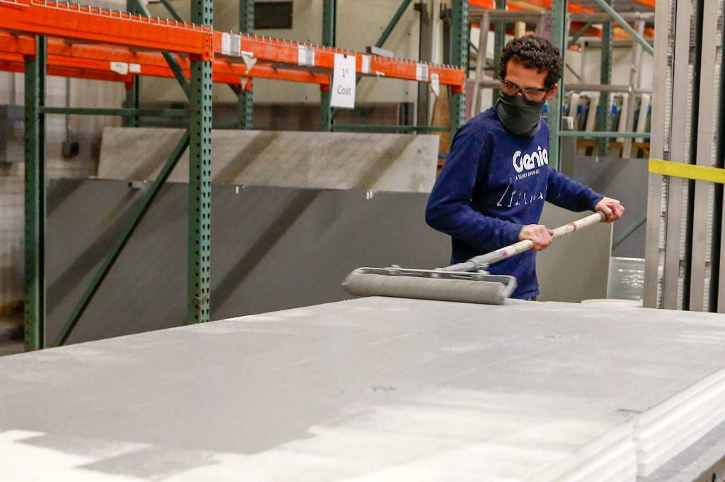 Floors are painted as part of the fabrication process at Pallet in Everett. (Kevin Clark / The Herald)