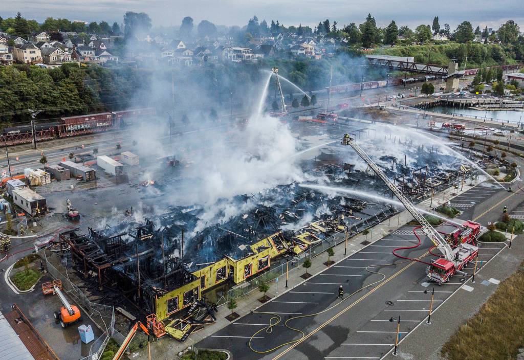 Smoke rises from the Waterfront Apartments on Marine View Drive on July 16 in Everett. (Olivia Vanni / The Herald)