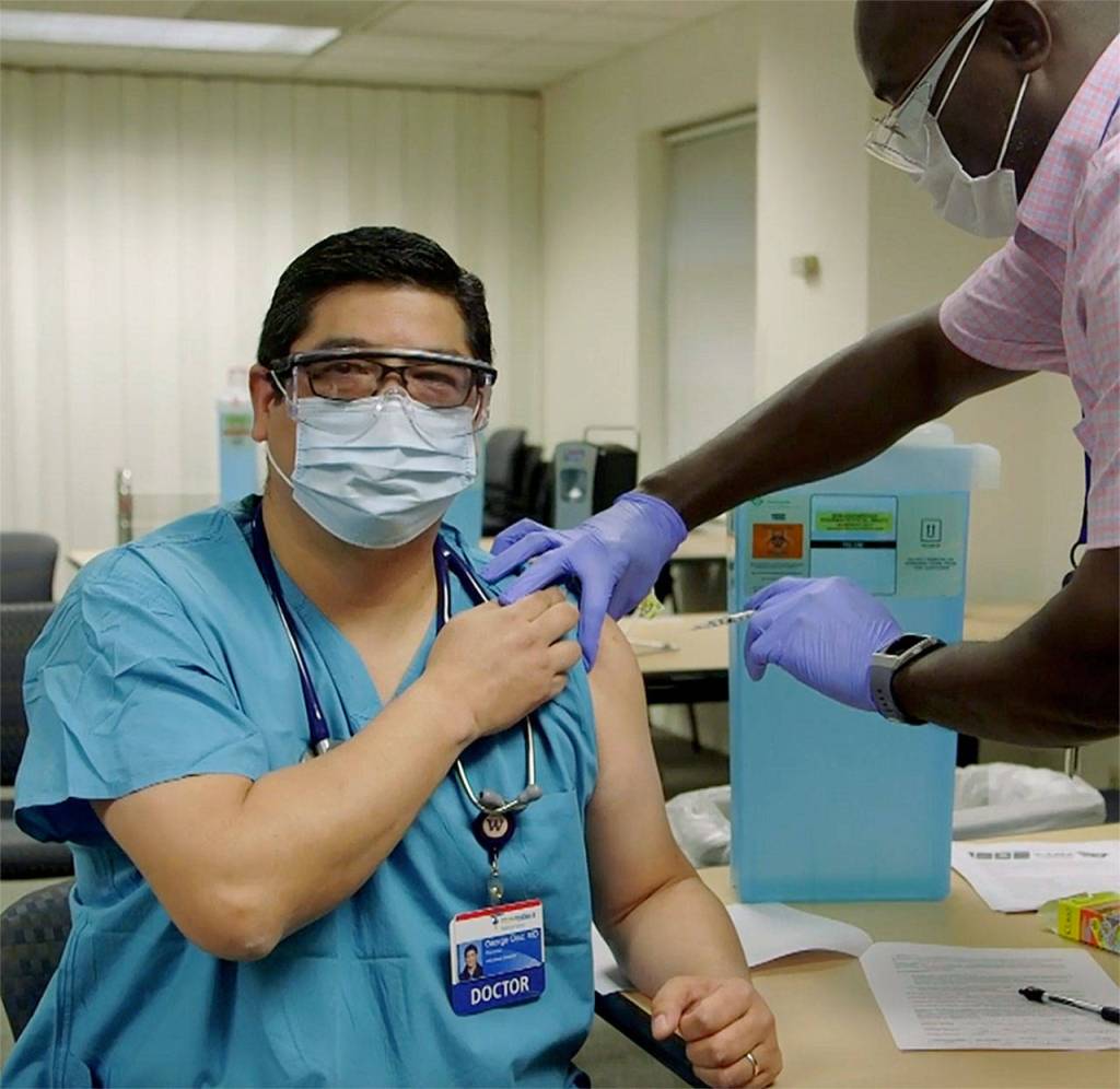 Dr. George Diaz is vaccinated at Providence Regional Medical Center Everett on Dec. 18. (Providence)