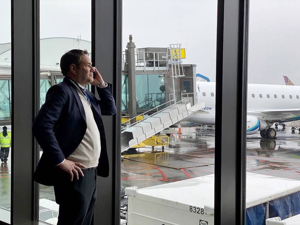 Brett Smith, CEO of Propeller Airports, takes a call March 2 inside the Paine Field terminal. (Sue Misao / The Herald)