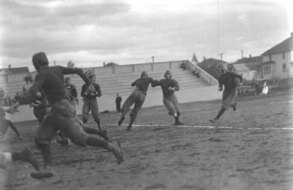 Everett High Schools Dan Michel carries the ball during a Oct. 4, 1913 game against Bellingham at Athletic Field in Everett. (Everett Public Library Northwest History Room)