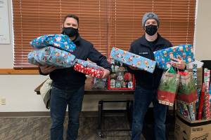 Firefighters deliver gifts to families in need.  (Snohomish Regional Fire Rescue)