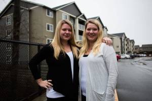Britt Morgan, left, who manages the Scriber Creek Apartments and twin sister Rachel Morgan, who manages the Madison Way Apartments on Wednesday, Dec. 30, 2020 in Lynnwood, Wa. (Olivia Vanni / The Herald)