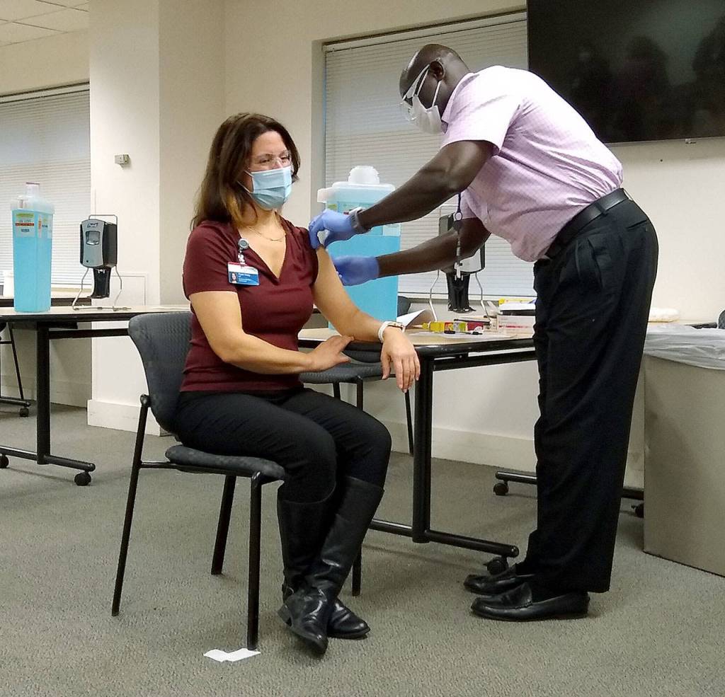 Dr. Ryan Keay, medical director for Providence Regional Medical Center Everett’s emergency department, is vaccinated on Dec. 18, 2020. (Providence Regional Medical Center Everett) 201218