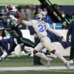 Seahawks wide receiver David Moore (left) makes a catch in front of Rams cornerback Darious Williams (31) during the second half of a game Dec. 27, 2020, in Seattle. (AP Photo/Scott Eklund)