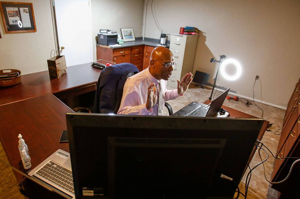 State Rep. John Lovick attends an online caucus meeting from his home Friday in Mill Creek. (Kevin Clark/The Herald)