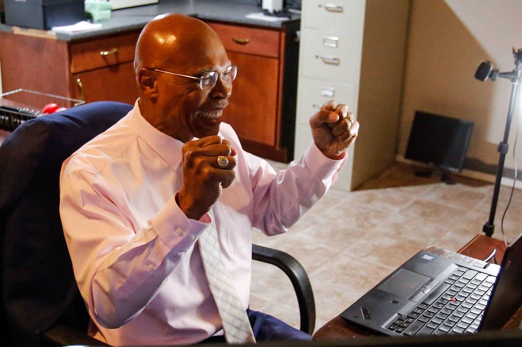 State Rep. John Lovick reacts during a caucus meeting before being sworn in at his home Friday in Mill Creek. (Kevin Clark/The Herald)