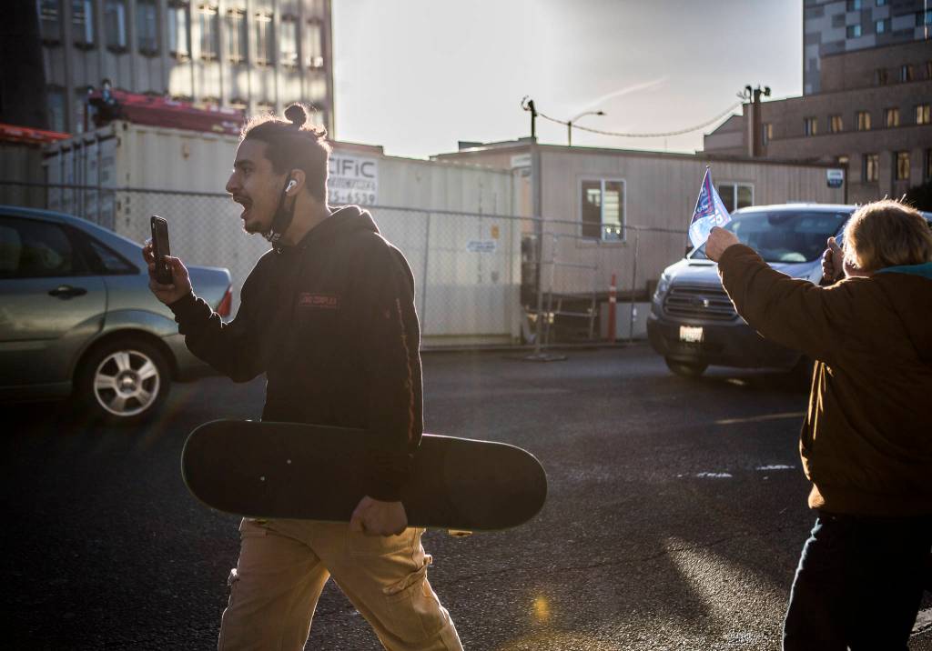 Benjamin Hansen yells at Trump supporters as they drive by the Snohomish County Courthouse on Wednesday, Jan. 6, 2020 in Everett, Wa. (Olivia Vanni / The Herald)