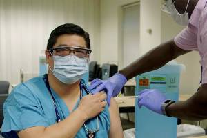 Dr. George Diaz is vaccinated at Providence Regional Medical Center Everett on Friday. (Providence) 20201218