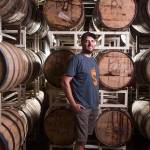Head brewer Hollis Wood at Skookum Brewery, with barrel-aged beers in Arlington. (Andy Bronson / The Herald)