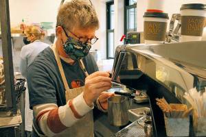 Annabelle Richardson pours a latte at Langley Kitchen. (Kira Erickson / Whidbey News-Times)