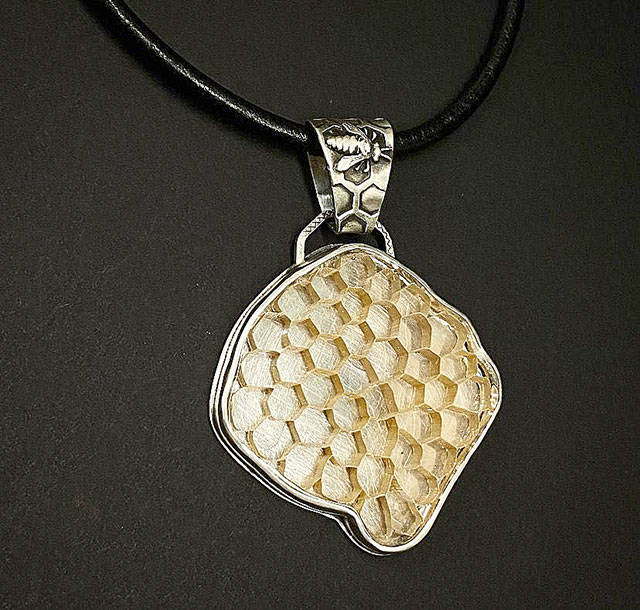 This sterling silver honeycomb and bee necklace is from Krystal Mundays Honeycomb Collection.