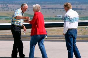 FILE - In this July 11, 2018, file photo, rancher Dwight Hammond Jr., left, is embraced by his wife, Susie Hammond, after arriving by private jet at the Burns Municipal Airport in Burns, Ore. Hammond and his son Steven, convicted of intentionally setting fires on public land in Oregon, were pardoned by President Donald Trump. The federal government has proposed awarding grazing allotments to the Hammonds, whose case sparked the takeover of a federal wildlife refuge by right-wing extremists in 2016. (Beth Nakamura/The Oregonian via AP, File)