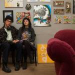 Artists Amber and Alex Vincini sit by examples of their artwork outside their Everett studio Wednesday. (Andy Bronson / The Herald)