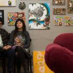 Artists Amber and Alex Vincini sit by examples of their artwork outside their studio on Wednesday, Jan. 13, 2020 in Everett, Washington.  (Andy Bronson / The Herald)