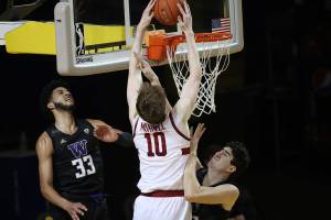 Stanford forward Max Murrell (10), center, dunks against Washington forward J'Raan Brooks (33), left, and center Riley Sorn (52), right, during the first half of an NCAA college basketball game in Santa Cruz, Calif., Thursday, Jan. 7, 2020. (AP Photo/Josie Lepe)