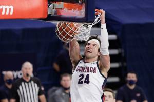 Gonzaga forward Corey Kispert dunks during the second half of an NCAA college basketball game against BYU in Spokane, Wash., Thursday, Jan. 7, 2021. (AP Photo/Young Kwak)