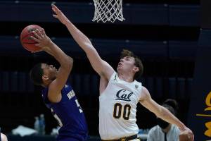 California guard Ryan Betley (00) blocks Washington guard Quade Green (55) during the second half of an NCAA college basketball game, Saturday, Jan. 9, 2021, in Berkeley, Calif. California won 84-78. (AP Photo/Tony Avelar)