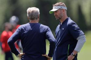 Seattle Seahawks offensive coordinator Brian Schottenheimer, right, talks with head coach Pete Carroll, left, following an organized team activity, Tuesday, June 4, 2019, at the team's NFL football training facility in Renton, Wash. (AP Photo/Ted S. Warren)