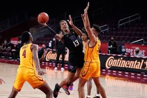 Washington forward Hameir Wright (13) shoots between Southern California forward Isaiah Mobley (3) and forward Evan Mobley (4) during the first half of an NCAA college basketball game Thursday, Jan. 14, 2021, in Los Angeles. (AP Photo/Marcio Jose Sanchez)