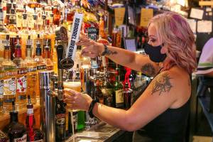 Carissa Hudson pulls a beer at Engel's Pub in Edmonds. At 86 years old, Engel's is one of the oldest bars in Snohomish County.  (Kevin Clark / The Herald)