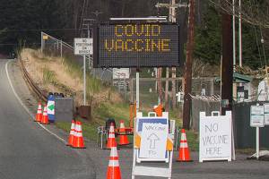 A sign in set up to alert that the vaccine station at the Evergreen State Fairgrounds, is by appointment only, on Monday, Jan. 18, 2020 in Monroe, Washington.  (Andy Bronson / The Herald)