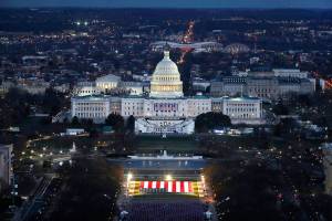 The U.S. Capitol building is prepared for the inauguration ceremonies for President-elect Joe Biden as the "Field of Flags" are placed on the ground on the National Mall on Monday, Jan. 18, 2021. in Washington, DC. Approximately 191,500 flags will cover part of the National Mall and will represent the American people who are unable to travel to Washington, for the inauguration. (Joe Raedle/Pool vias AP)