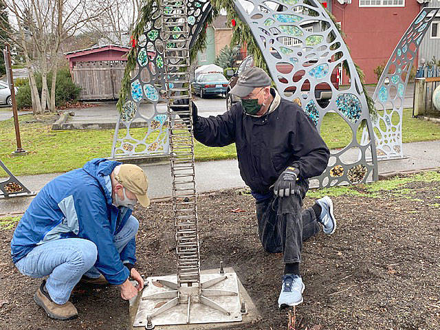 Artist Wayne Kangas, left, and Langley Arts Fund member Don Wodjenski install the Village by the Seas newest public art feature, a weather vane.