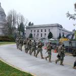 Washington National Guard members walk in formation away from the Legislative Building, Wednesday, Jan. 20, 2021, at the Capitol in Olympia, Wash. Members of the Guard and Washington State Patrol troopers have been in place all week on the campus providing security against possible protests connected with the inauguration of President Joe Biden and the departure of former President Donald Trump in Washington, D.C. (AP Photo/Ted S. Warren)