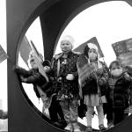 Children from the Childrens Workshop, an arts and science preschool, pause in a sculpture after walking their neighborhood with flags they made in celebration of the inaugurations of President Joe Biden and Vice President Kamala Harris, Wednesday, in Seattle.