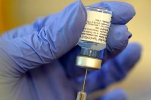 A pharmacist prepares a syringe of the Pfizer-BioNTech COVID-19 vaccine Friday, Jan. 8, 2021, at Queen Anne Healthcare, a skilled nursing and rehabilitation facility in Seattle. Pfizer has committed to supply up to 40 million doses of its COVID-19 vaccine this year to a World Health Organization-backed effort to get affordable vaccines to 92 poor and middle-income countries. The deal announced Friday, Jan. 22 will supply the shots to the program known as COVAX.   (AP Photo/Ted S. Warren)