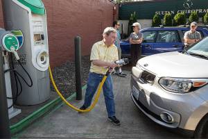 Ian Terry / The Herald

Brian Henderson, of Renton, plugs in his Kia Soul EV electric vehicle at a charging station in Sultan on Wednesday, June 7. Henderson and a group of fellow electric car drivers made the trip from Everett's City Hall to Spokane's City Hall late last week in an effort to raise awareness about convenient charging locations along U.S. Highway 2.

Photo taken on 06072017