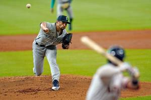 Seattle Mariners starting pitcher Kendall Graveman, left, throws to Houston Astros' Alex Bregman during the first inning of a baseball game Monday, July 27, 2020, in Houston. (AP Photo/David J. Phillip)