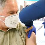 Washington Gov. Jay Inslee gets his first shot of the Moderna COVID-19 vaccine on Friday from Elizabeth Smalley, a medical assistant at a Sea Mar Community Health Center in Olympia. Inslees wife, Trudi, also received the first dose of the vaccine. (AP Photo/Ted S. Warren)