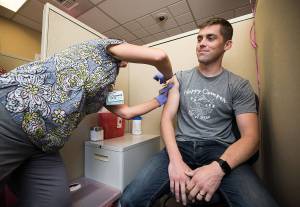 Rocky Oliphant gets a flu shot at the Everett Clinic on Tuesday, Oct. 2, 2018 in Everett, Wa. (Andy Bronson / The Herald)