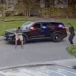 A frame from video taken by a nearby security camera shows a Bothell police officer (right) shooting a man who allegedly charged him with a knife. (Snohomish County Multiple Agency Response Team)
