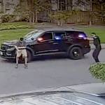 A frame from video taken by a nearby security camera shows a Bothell police officer (right) shooting a man who allegedly charged him with a knife. (Snohomish County Multiple Agency Response Team) 20210128