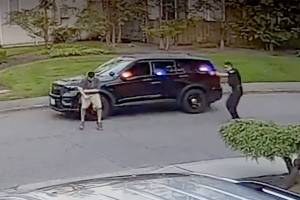 A frame from video taken by a nearby security camera shows a Bothell police officer (right) shooting a man who allegedly charged him with a knife. (Snohomish County Multiple Agency Response Team) 20210128