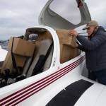 Pilot Greg Bell loads boxes into his Diamond DA-40 plane at Arlington Municipal Airport on Thursday. (Andy Bronson / The Herald)